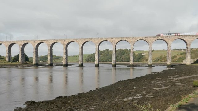 Passenger train crossing River Tweed on the historic Royal Borders Bridge built in 1850 for railroad traffic across the river at Berwick-upon-Tweed, Northumberland, England