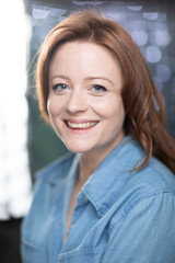 Portrait of white skin ginger girl with blue eyes with denim shirt