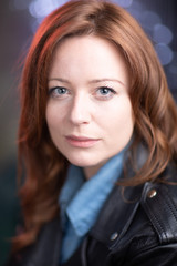 Portrait of white skin ginger girl with blue eyes with leather jacket