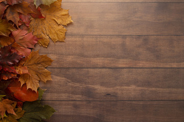 Naklejka na ściany i meble Fall Themed Background on a Wooden Surface