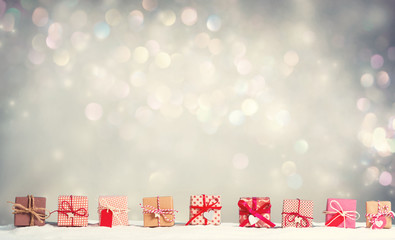 Collection of Christmas gift boxes in a snow covered landscape