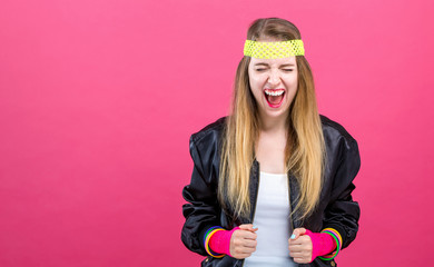 Woman in 1980's fashion theme on a pink background