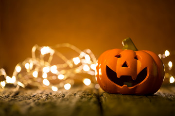 Halloween pumpkin and lighting on wooden background