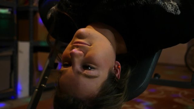 Woman flipping on inversion table - exercise spinal concept