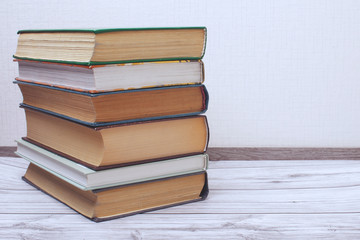 Old books on a wooden shelf.