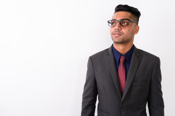Young Indian businessman wearing suit against white background