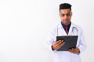 Young Indian man doctor against white background