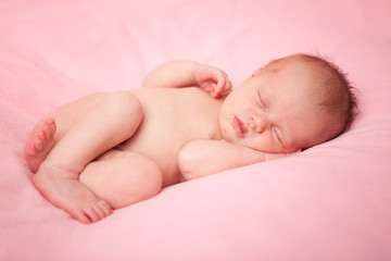 Newborn Baby Girl Sleeping Peacefully, Isolated on Pink
