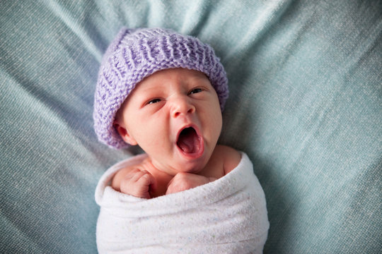 Sleepy Newborn Baby Yawning, Wrapped in Blanket