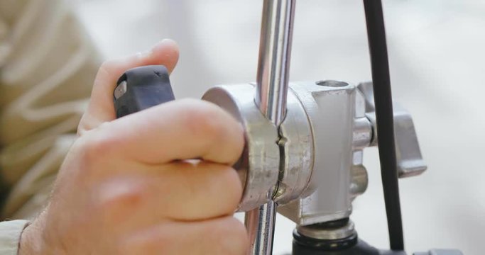 Hand of male illuminator set up stand for shooting