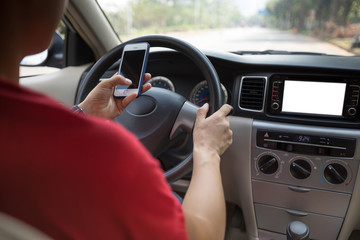 Hand  using smartphone while driving car