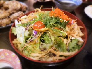 a bowl of salad with vegetables and greens / korean style