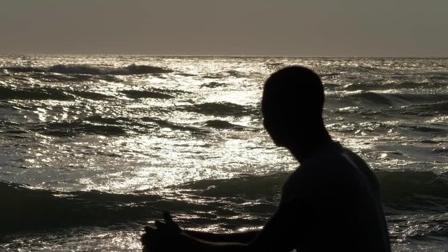 focus on Lonesome,migration, Africa.Young  african man silhouette contemplting the sea.