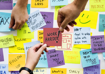 Messy sticky notes and Work harder concept