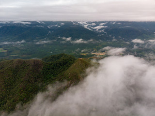 Aerial view of mountain with cloudy background.