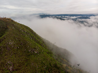 Aerial view of mountain with cloudy background.
