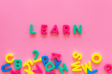 Children learn read concept. Word learn written by plastic letters on pink background top view space for text