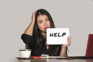 young stressed and depressed Asian Japanese woman working overwhelmed and exhausted as corporate business employee asking for help desperate and frustrated