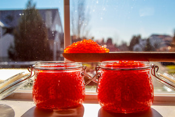 View at jars with prepared red salmon caviar.