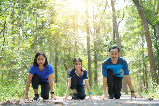Asian family exercising and jogging together at the park