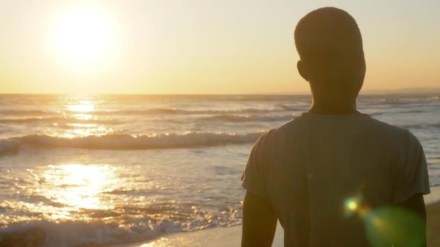 sad young african man walking alone on the beach.migration,Missing homeland