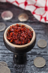 shisha with Apple flavor in a glossy black bowl, cooked for Smoking.