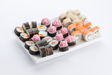 Sushi set and composition at white background. Japanese food restaurant, sushi maki gunkan roll plate or platter set.
