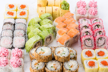 Sushi set and composition at white background. Japanese food restaurant, sushi maki gunkan roll plate or platter set.