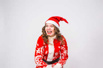 Holiday, Christmas and people concept - Angry woman in santa costume with bag of presents