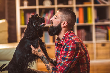 Handsome man with cute dog at home