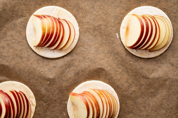 Cooking process of galetta, biscuit with apples on paper background. Apple pie with cinnamon.