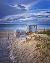 Romantic wedding registry office on the beach at the baltic sea with beach chair and blue clouds.