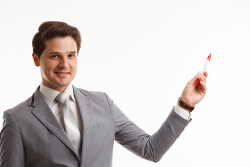 Businessman writing or drawing on screen, in front of white background.