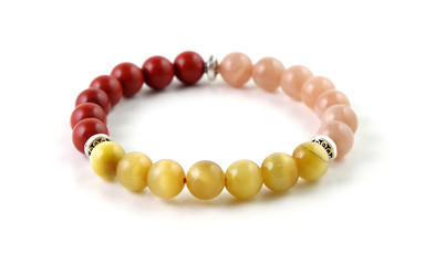 Colorful gemstone bracelet with red jasper, peach moonstone and cat's eye - tiger's eye gemstone beads, isolated on white background