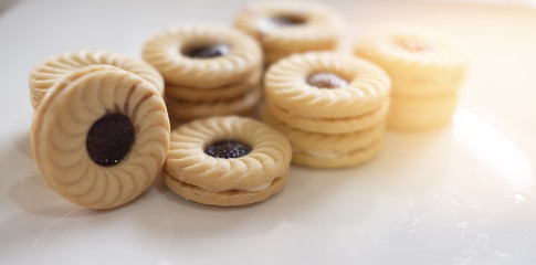 TART SANDWICH COOKIES WITH CREAM & STRAWBERRY FLAVORED JAM. selective focus. light leak effect