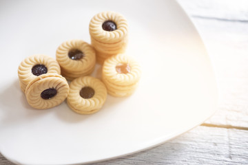 TART SANDWICH COOKIES WITH CREAM & STRAWBERRY FLAVORED JAM. selective focus. light leak effect