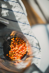 Kettle with sea-buckthorn on the table