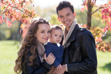 Fototapeta premium family with a baby in autumn park