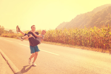 happy couple jogging along a country road