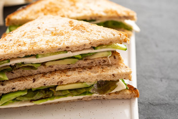 Healthy vegetarian sandwich with arugula, lettuce and avocado, mustard,cucumber. Close-up. Healthy food.