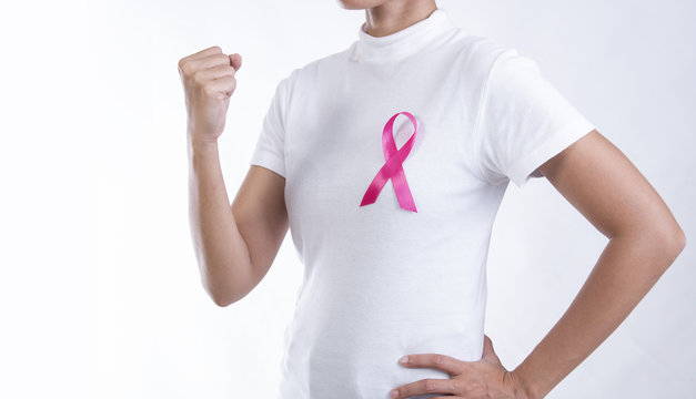 Woman in white t-shirt with pink ribbon on chest. strong symbol of breast cancer awareness and international women day campaign.
