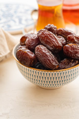 Fresh Medjool Dates in a bowl. Ramadan kareem. White background. Turkish style. Copy space.