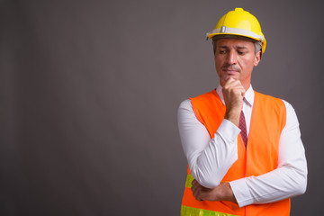 Portrait of man construction worker against gray background © Ranta Images
