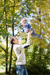 Fototapeta premium dad with baby in autumn park