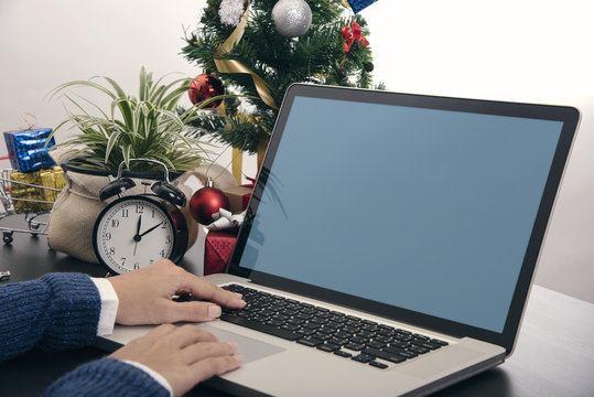 Business Hand Using Computer Blank Screen Mockup On Desk. Concept Office Christmas And Happy New Year.