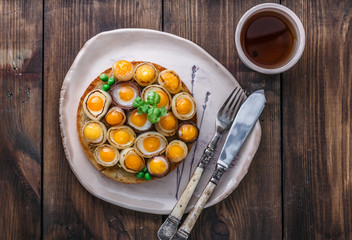 Fried quail eggs and onion on toasted bread, copy space, top view