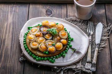 Fried quail eggs and onion on toasted bread, copy space, top view