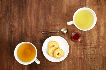 A photo of tea, shot from the top on a dark wooden background with a place for text