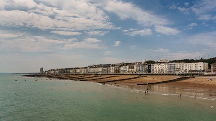 Fototapeta na wymiar Hastings coastline with its beach on a sunny summer day - photo shot from the pier
