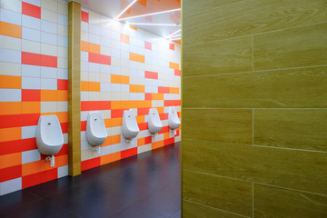 row of urinals men public toilet